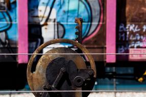 Old, rusty wagon, with the colorful and beautiful graffiti, in the port