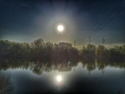 Beautiful river with trees on the shore, in light, with reflection, in summer