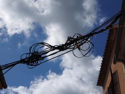 twisted electrical cables on the background of the sky