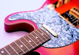 orange and pink electric guitar