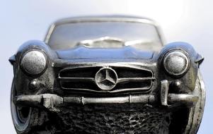Beautiful, shiny, vintage Mercedes 300sl car, in sunlight, at blue sky on background