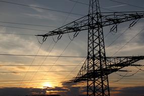 Electricity pylon, at background with the beautiful evening sky with colorful sunset