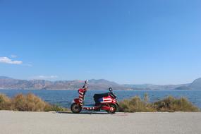 electric scooter by the lake on a sunny day