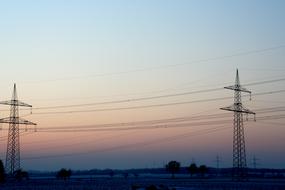 Beautiful landscape with the power poles at colorful, gradient sunrise in winter
