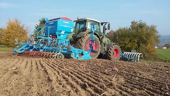 big tractor on arable field on a sunny day