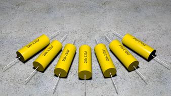yellow capacitors on a gray surface