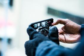 girl holding a phone in her hands on a blurred background
