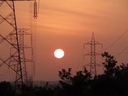 Beautiful landscape with electric towers and trees, at colorful sunset in Shimoga, Karnataka, India