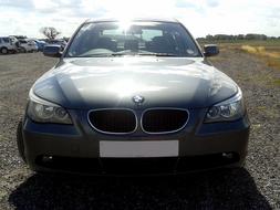 Front of the beautiful, shiny BMW car, outside, near the other cars