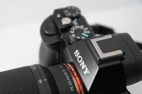 Close-up of the beautiful, black and red Sony Alpha 7 camera with hot shoe