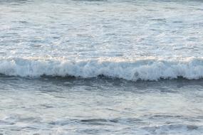 Beautiful, white waves of the ocean, in light