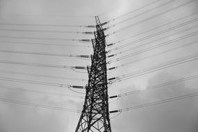 Black and white photo of the power lines under cloudy sky