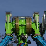 Cloe-up of the shiny, colorful amusement park equipment, at blue sky on background