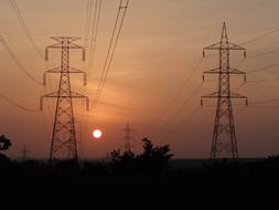 Electric pylons on the beautiful landscape, at colorful sunset, in Shimoga, Karnataka, India