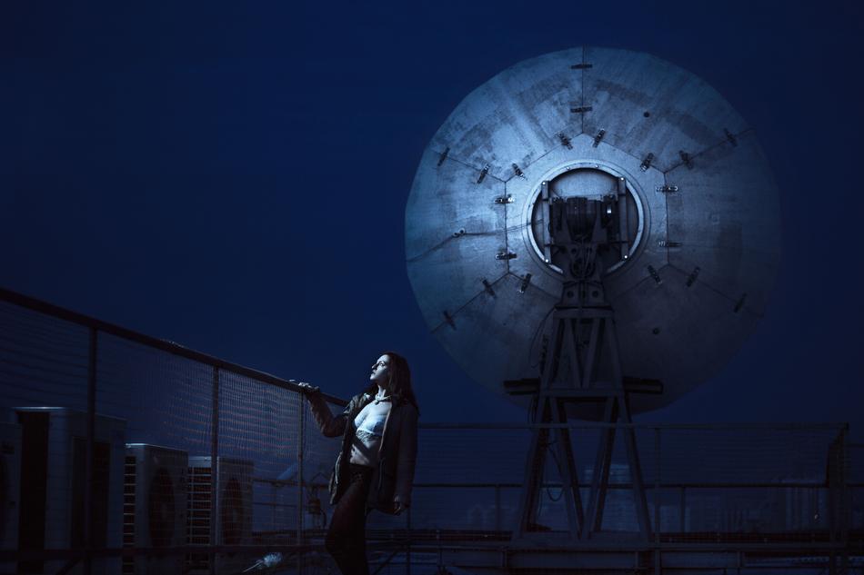 satellite dish and woman at night