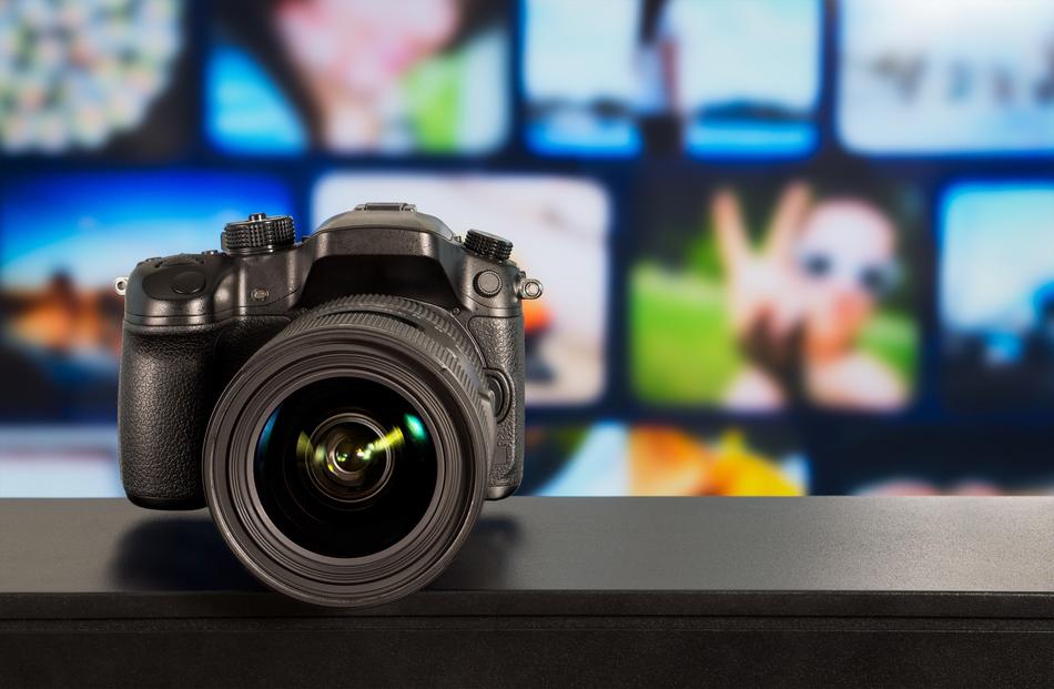 Photography, concept, Dslr Camera in front of blurred photos