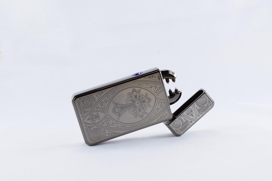 Beautiful arc lighter with the beautiful, engraved patter, on the white surface