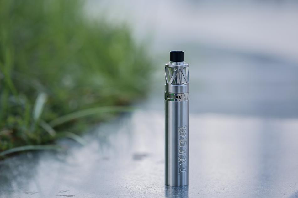 electronic cigarette on the background of the lawn