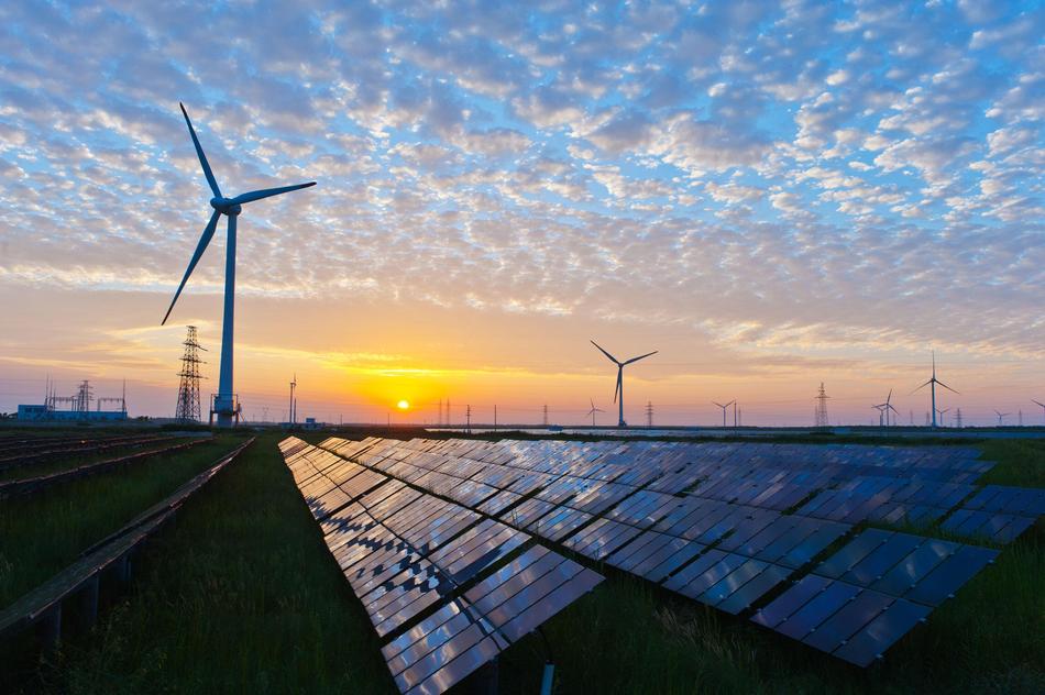 wind stations and solar panels against the evening sky