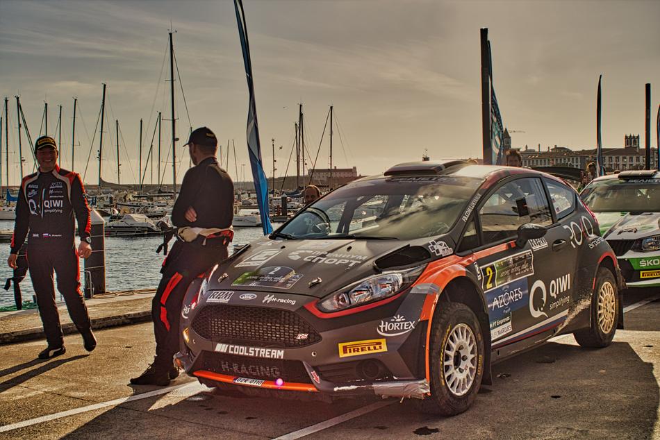 uniformed racers at sorts car on embankment, portugal, azores