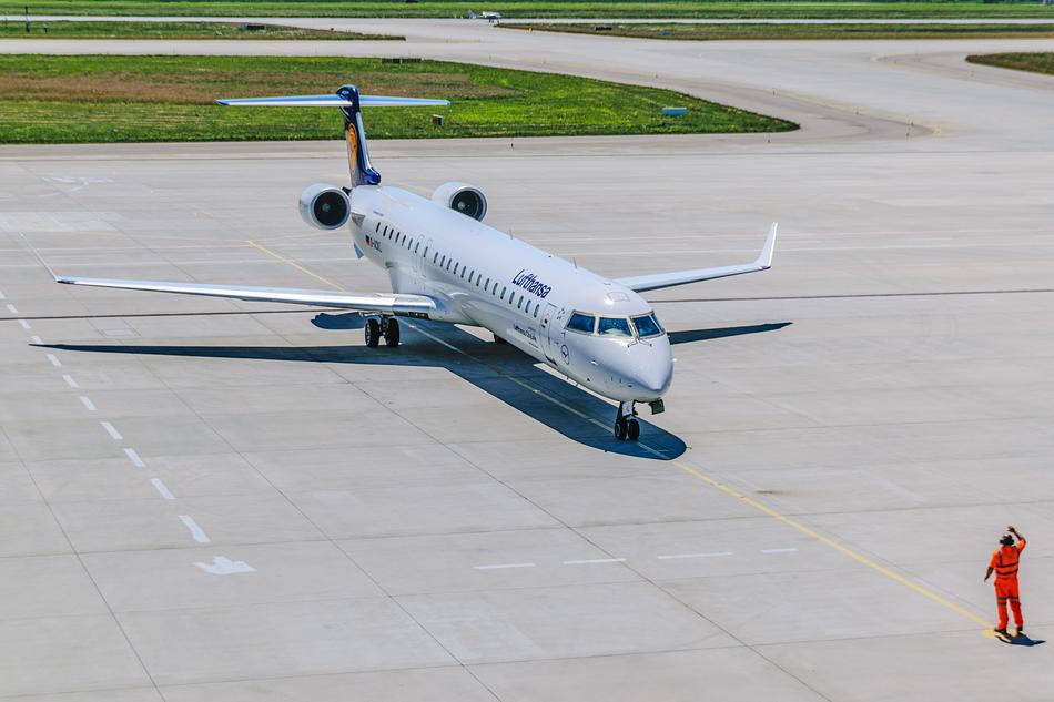 Shiny 'Lufthansa' plane in the airport of Germany, near the person