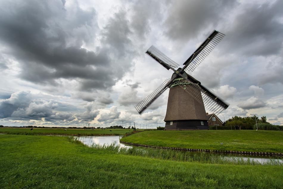 windmill on the shore of a pond in Holland