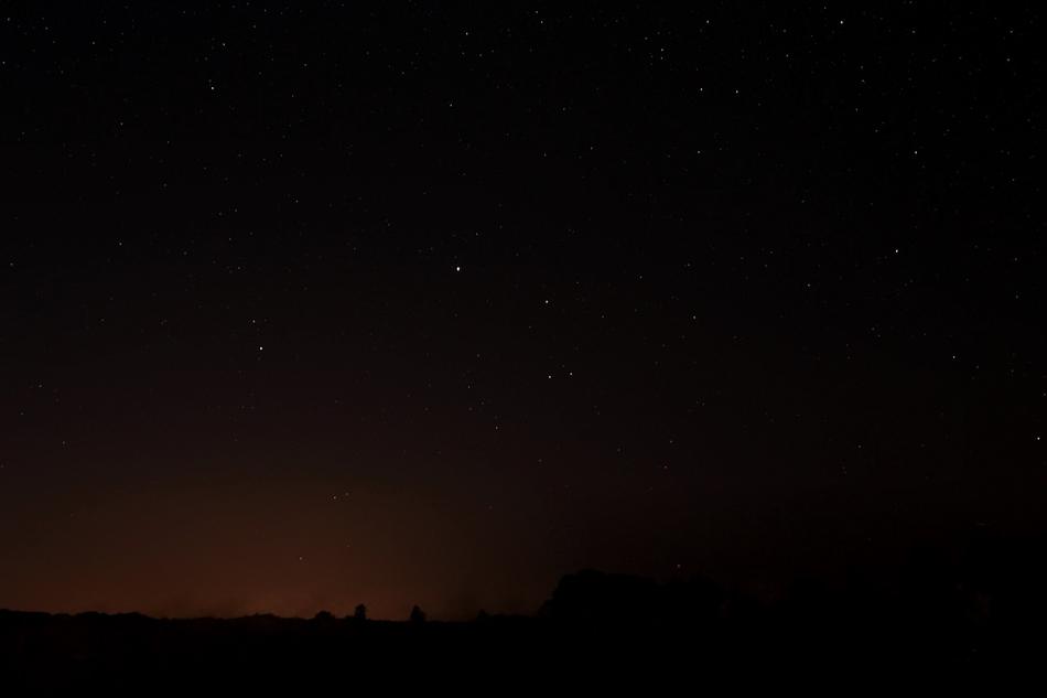 Beautiful dark sky with colorful stars above the landscape