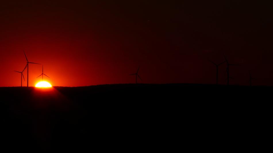 wind turbines on the background of the red night sky