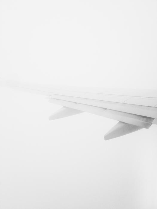 Wing of the airplane in fog
