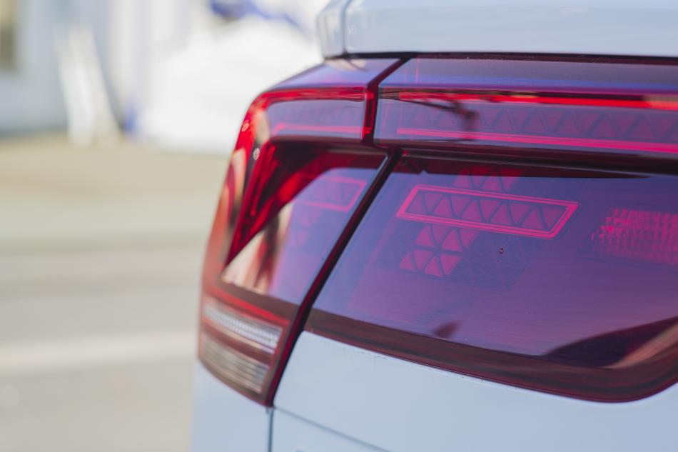 Back view with the red spotlight of the beautiful, white Auto, on the street