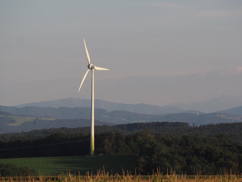 Beautiful and colorful landscape with the pinwheel on the green hills