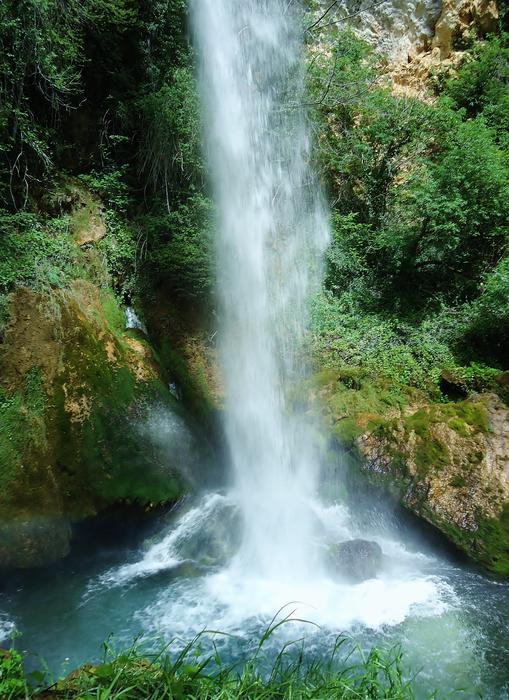 Beautiful waterfall, among the green and yellow plants in Drôme, France