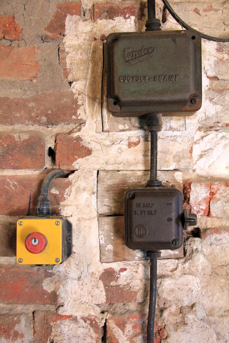 Close-up of the electric switch on the brick wall