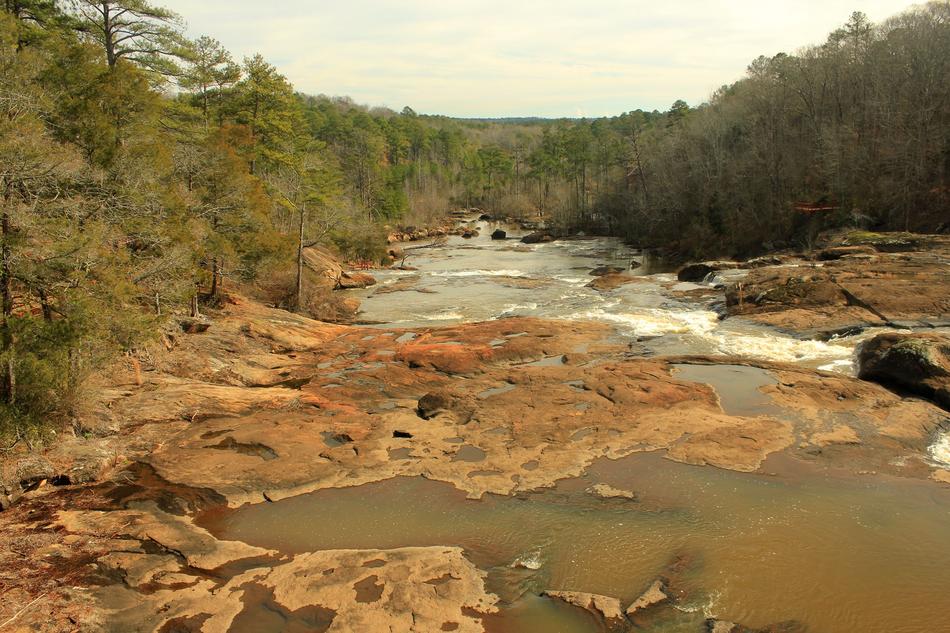 Beautiful and colorful river with rocks, among the forest with colorful trees