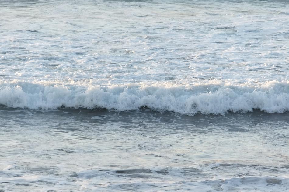 Beautiful, white waves of the ocean, in light