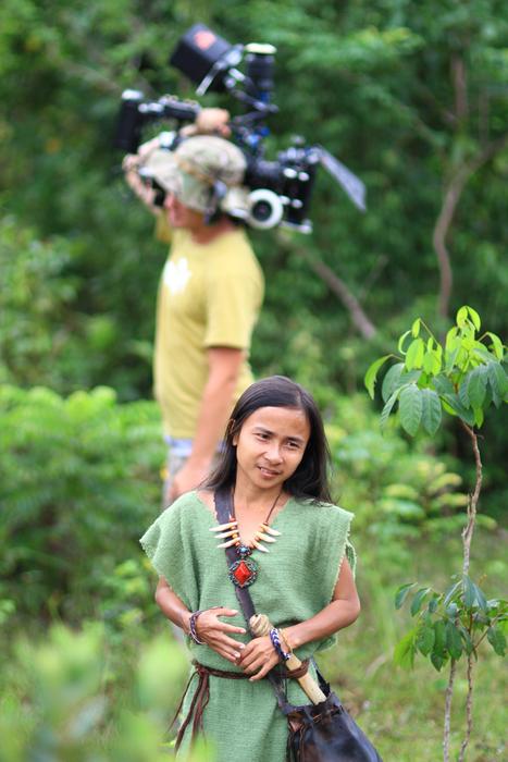 People on the movie production, among the colorful plants of the forest