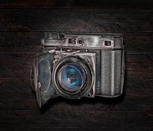 retro camera on dark wooden background