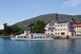 Beautiful town hall on the coast of Tegernsee, near the green mountains in Upper Bavaria, Germany