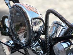 Close-up of the beautiful, shiny spotlight of motorcycle