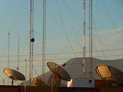 Satellite dishes for radio, at colorful and beautiful sky with clouds on background