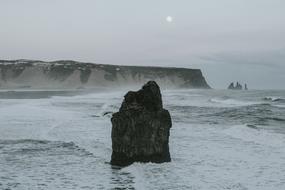 black sharp rock by the ocean