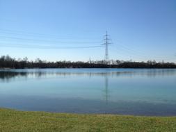 distant view of the power poles on the lake shore