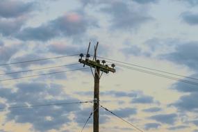 cloudy sky above the electric pillar