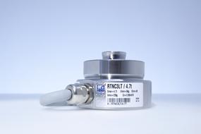 Close-up of the metal load cell, on the white surface