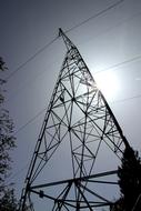 high voltage line silhouettes in bright sun