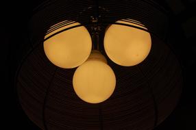 three yellow Light Bulbs at darkness