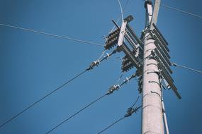 mast with electric wires on a sunny day