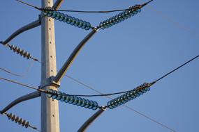 Close-up of the power lines, with the blue glass, at blue sky on background
