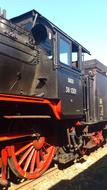 vintage steam locomotive on rails close up