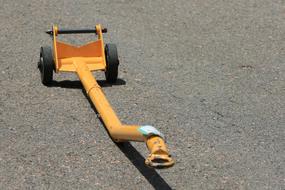 Close-up of the yellow tow bar, on the asphalt